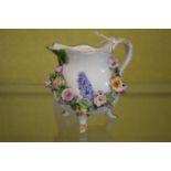 A small Meissen floral encrusted jug.