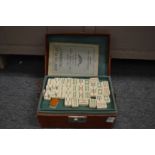 A Mahjong set in a fitted leatherette case.