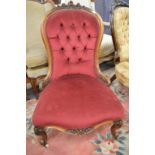 A Victorian rosewood framed button upholstered nursing chair.