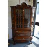 A good 18th/19th century Dutch walnut cabinet on chest of bombe form.