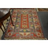 A Persian style rug with geometric decoration.