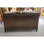 A stylish ebonised four door sideboard with brushed steel inlaid decoration.