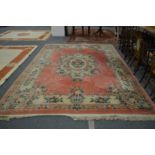 A Chinese pink ground carpet with floral decoration 12ft 6ins x 9ft 2ins.