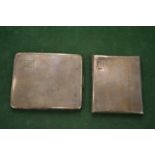 Two silver cigarette cases.