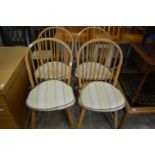 A set of four spindle back kitchen chairs.