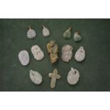 A collection of Chinese carved jade amulets and pendants.