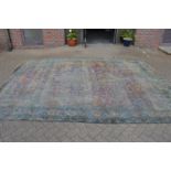 A large early Persian carpet (very badly worn), approx. 13ft x 9ft 10ins.