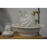 A shell shaped jug and bowl set with matching vase and soap dish.