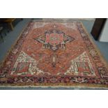 A good Heriz carpet, beige ground with stylized decoration 12ft x 8ft 6ins.