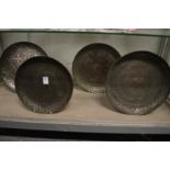 Four early Islamic engraved silvered copper dishes.