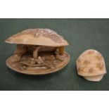 A Japanese ivory clam shaped okimono and a similar item.