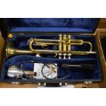 A cased B & M Champion trumpet.