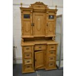A large 19th century continental pine two-part cupboard.