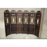 A good Chinese carved and pierced hardwood miniature six panel folding screen inset with jade