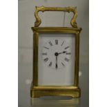 A brass carriage clock.