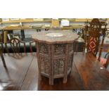 A good eastern carved wood and inlaid occasional table with pierced folding base.