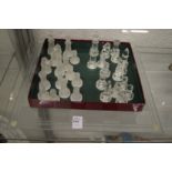 A glass chess set and board.