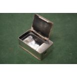 A silver vesta box.