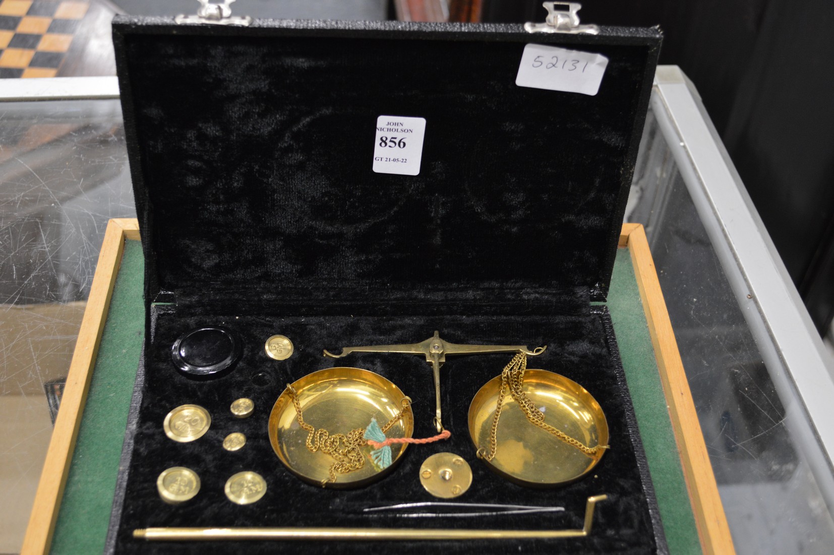 A cased set of gold scales.