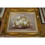 Two still lifes of flowers in a vase, oil on canvas in decorative gilt frames, together with another