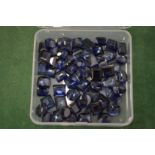 A box of sapphire coloured stones.