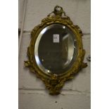 A small cast brass framed decorative mirror.