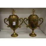 A pair of Indian engraved brass twin handled pedestal cups and covers.