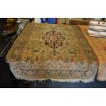 A Persian silk rug, beige ground with floral decoration.