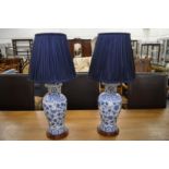 A pair of Chinese style blue and white vase lamps.