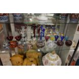 A shelf of colourful glassware.