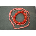 A coral necklace and an amber style bracelet.