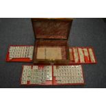 A Mahjong set in a Victorian walnut sewing box.