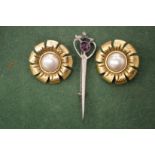 A pair of gilt metal ear clips and a plaid brooch.