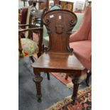 A Victorian oak hall chair.