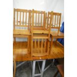 A kitchen drop-leaf gate-leg table with four chairs.