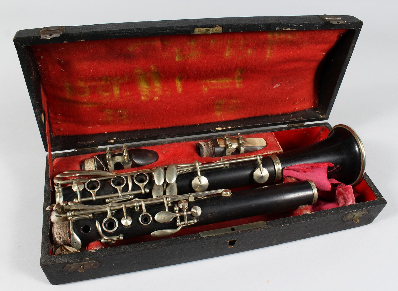 A CLARINET in a folding leather case.