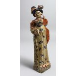 A PRIMITIVE CARVED WOOD AND PAINTED FEMALE FIGURE, possibly American. 10ins long.