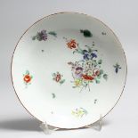 AN 18TH CENTURY BRISTOL SAUCER DISH painted with flowers, crossed swords mark in underglaze blue.