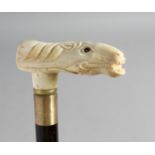 A WALKING STICK with carved bone handle of a horse.