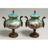 A VERY GOOD PAIR OF 19TH CENTURY SEVRES PALE BLUE CIRCULAR URNS AND COVERS painted with reverse