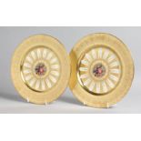 A GOOD PAIR OF AYNSLEY FRUIT PLATES with gold borders. 10ins diameter.