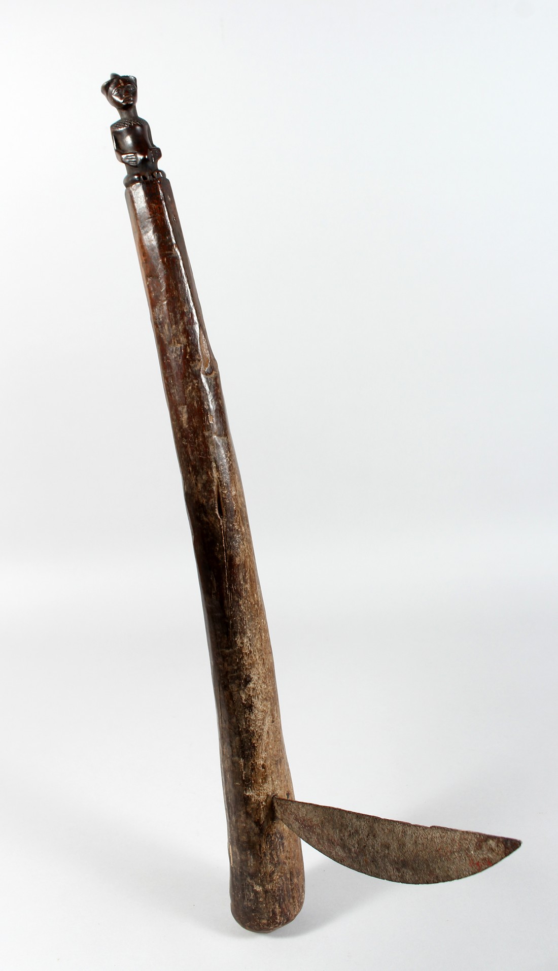 A TRIBAL AXE with metal blade. 23ins long.