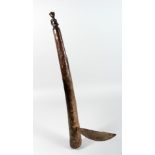 A TRIBAL AXE with metal blade. 23ins long.