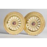 A GOOD PAIR OF AYNSLEY FRUIT PLATES with gold borders. 10ins diameter.