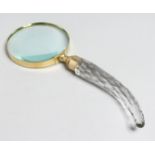 A MAGNIFYING GLASS with cut glass handle.