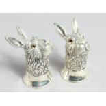A PAIR OF .800 WHITE METAL RABBIT SALTS AND PEPPERS.
