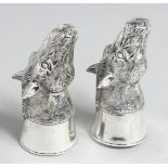 A PAIR OF 800 WHITE METAL HORSES' HEADS SALTS AND PEPPERS.