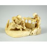 A JAPANESE CARVED IVORY OKIMONO GROUP, depicting a father a son, the father with his feet