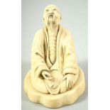 A CHINESE CARVED IVORY FIGURE of a kneeling man, mounted to an ivory base, with carved mark to base,