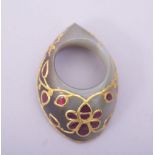 A FINE INDIAN JADE ARCHER'S THUMB RING, inset with coloured stones and gilt metal tracery, 4.5cm.